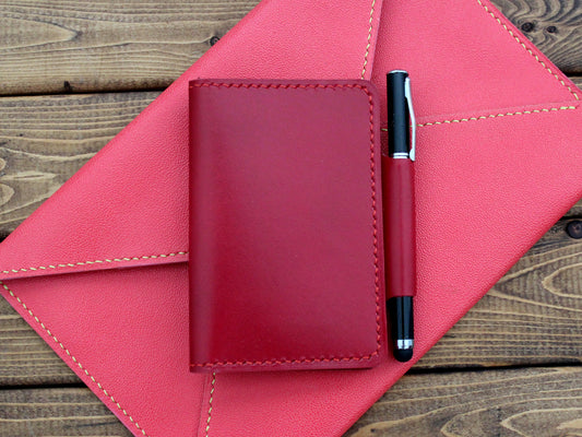 A red folio pocket journal wallet made of premium Italian leather with a pen loop