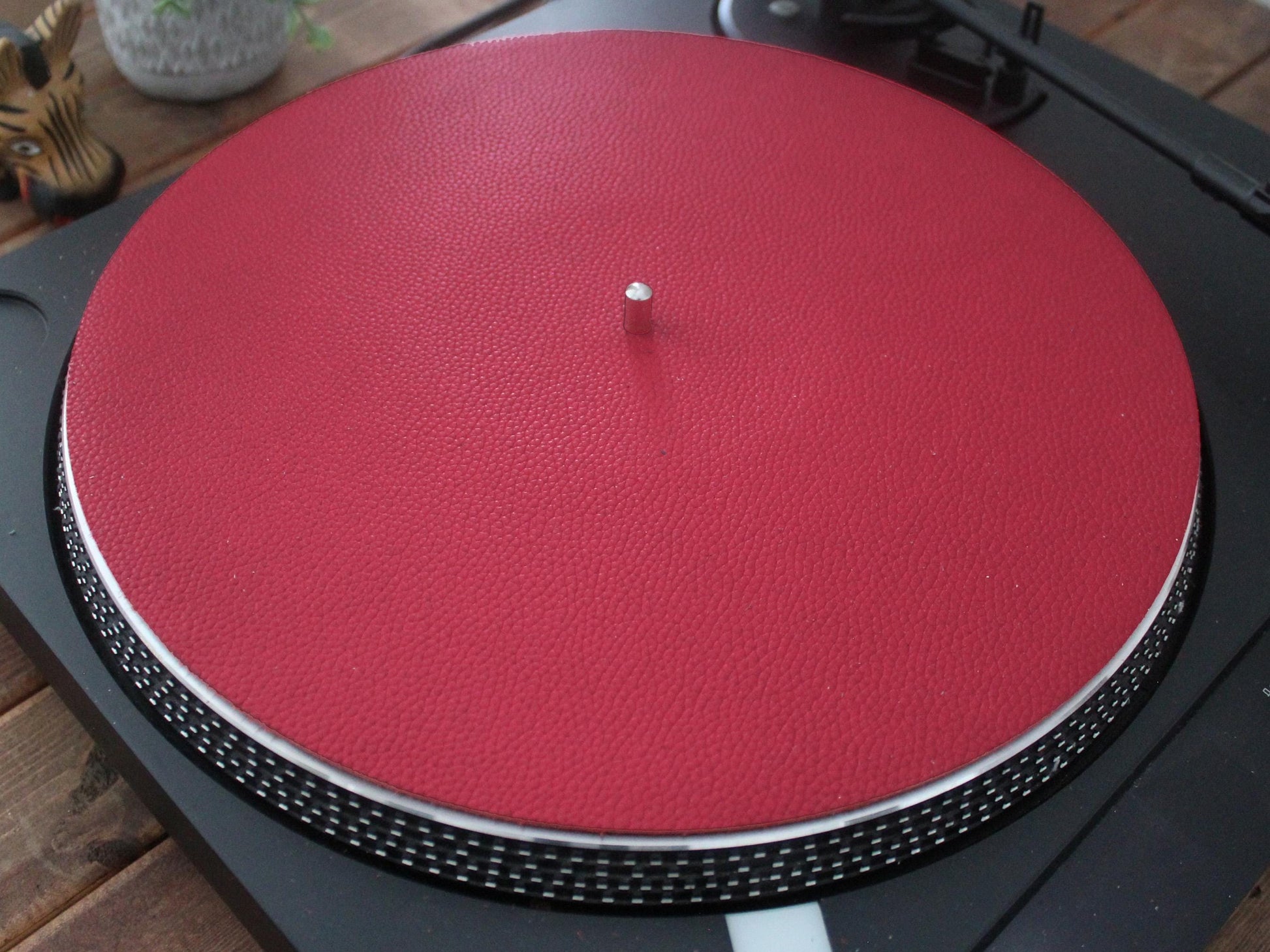 A red full grain leather turntable platter slip mat