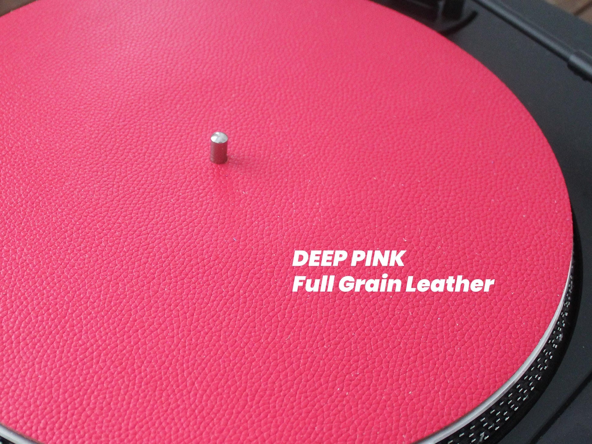 A pink red leather turntable platter mat