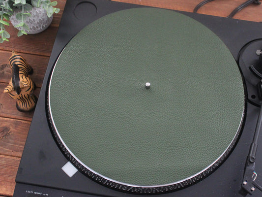 An olive green full grain leather turntable platter mat placed on a turntable