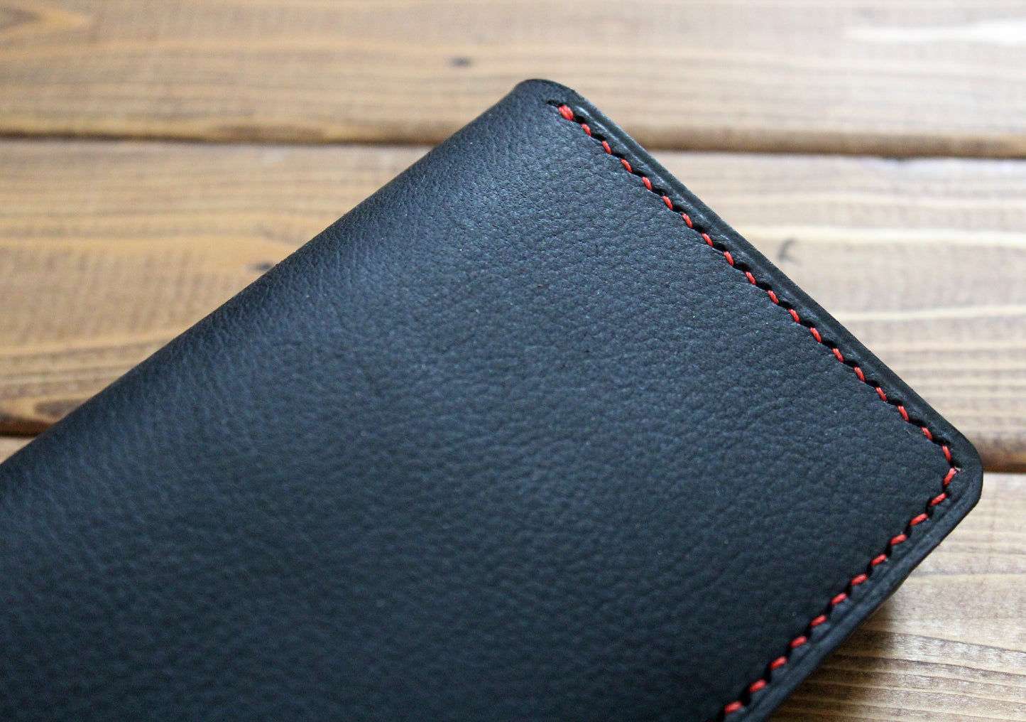Black leather wallet with red stitching