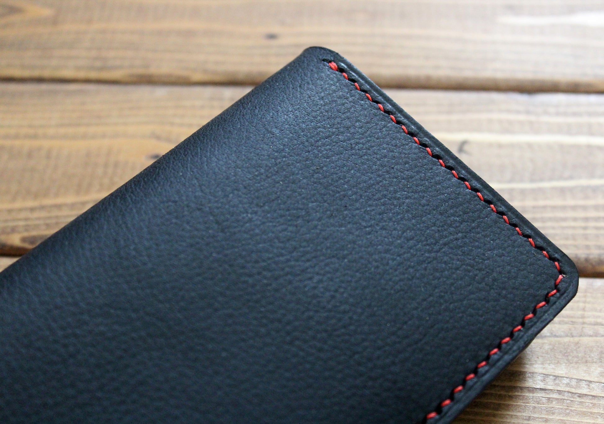 Black leather wallet with red stitching 